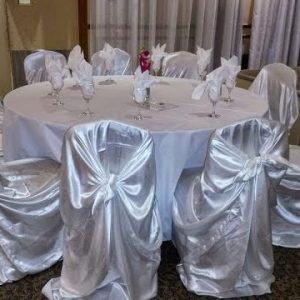 White table setting with draped chair covers for a formal event, decor rental by Decorentals2go Ottawa